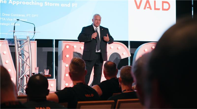 Drew Contreras speaking at VALDCON 2024 about the role of technology in the future of physical therapy.
