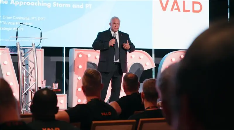 Drew Contreras speaking at VALDCON 2024 about the role of technology in the future of physical therapy.