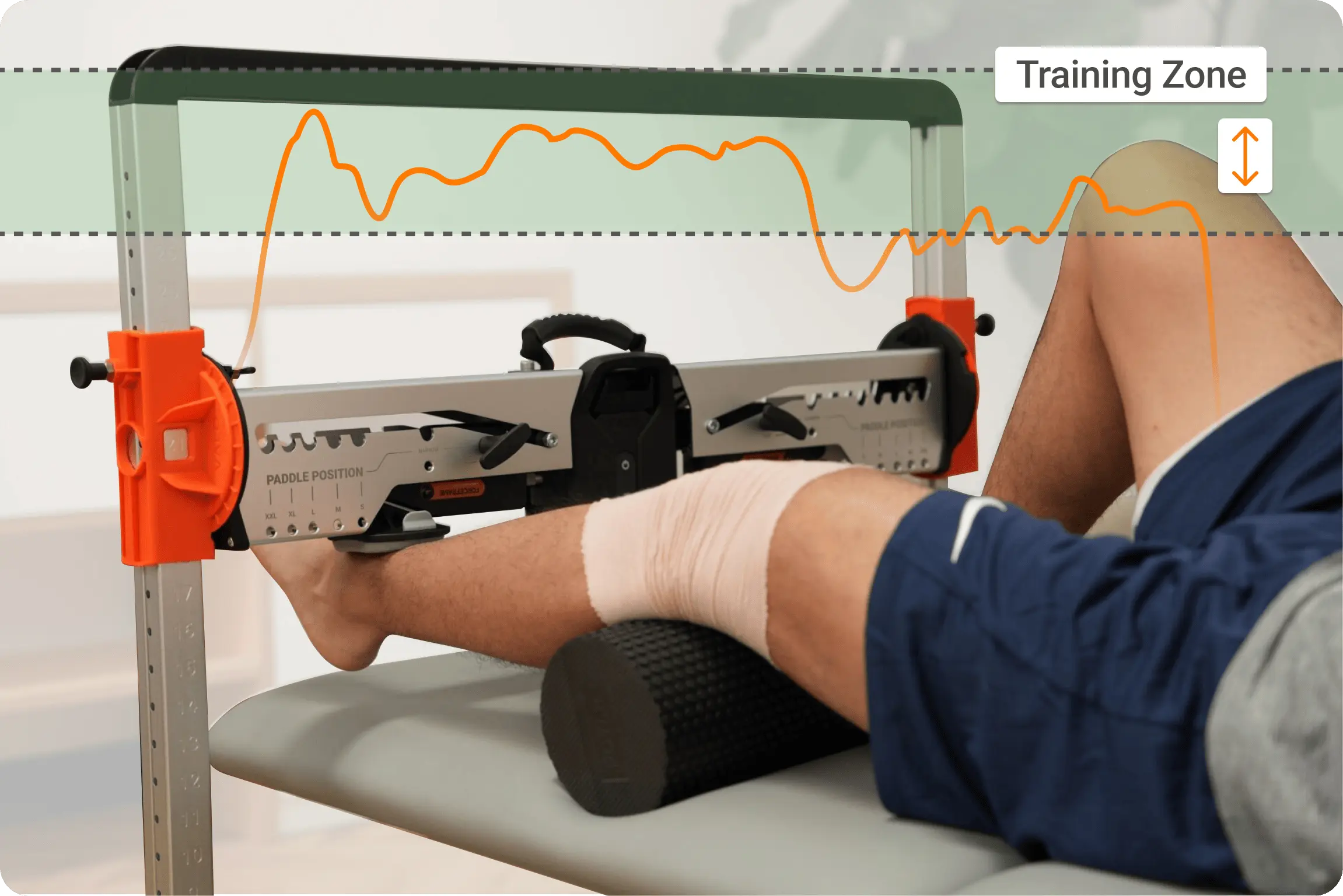 Patient performing long-lever knee extension isometrics with ForceFrame Training Mode for biofeedback.
