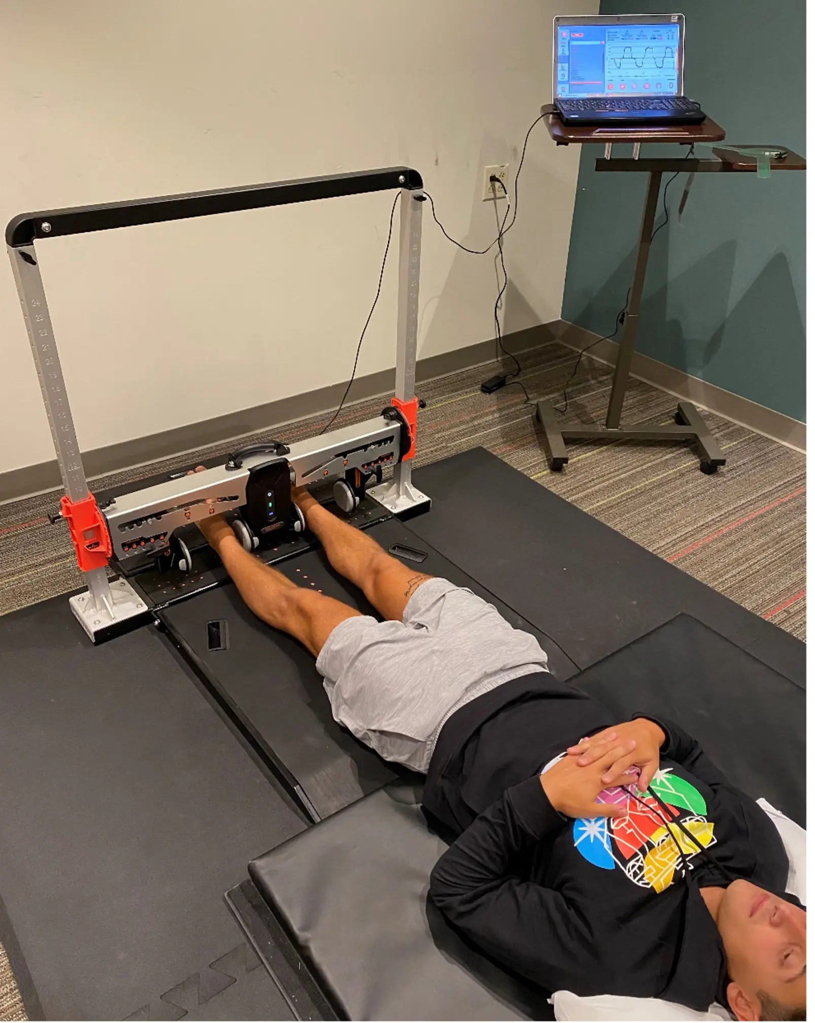 A collegiate soccer player returning for muscle strength testing at the tail-end of his rehab protocol, testing maximal hip adduction strength at 0° (long lever).